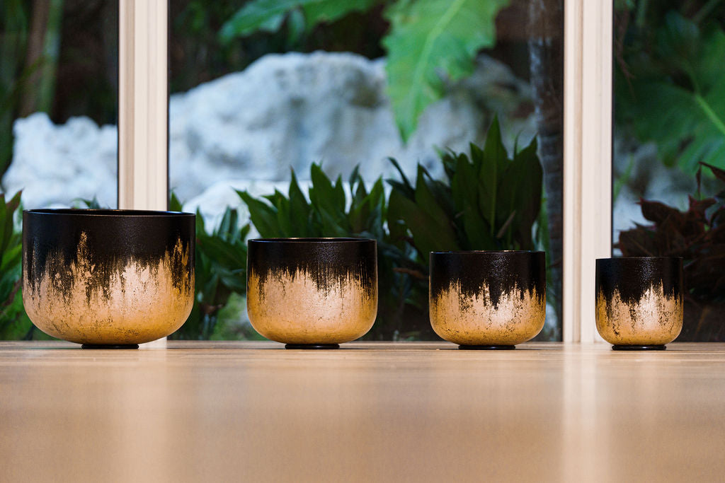 Luxury yoga lifestyle setup with Tibetan sound bowls, eco yoga mats, and natural textures for meditation.